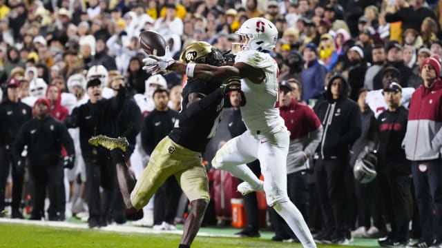 Oct 13, 2023; Boulder, Colorado, USA; Stanford Cardinal wide receiver Elic Ayomanor (13) pulls in a touchdown behind the pack of Colorado Buffaloes cornerback Travis Hunter (12) in overtime at Folsom Field. Mandatory Credit: Ron Chenoy-USA TODAY Sports