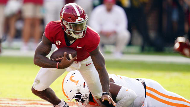 Alabama Crimson Tide quarterback Jalen Milroe (4) gets sacked behind the line of scrimmage by Tennessee Volunteers defensive lineman Omarr Norman-Lott (55) during the first half at Bryant-Denny Stadium.