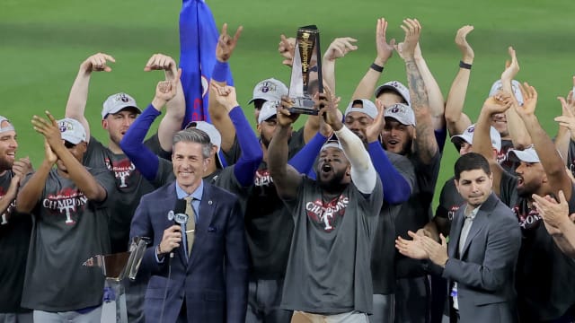 Oct 23, 2023; Houston, Texas, USA; Texas Rangers right fielder Adolis Garcia (53) celebrates with the American League championship series MVP trophy after winning game seven in the ALCS against the Houston Astros for the 2023 MLB playoffs at Minute Maid Park. Mandatory Credit: Erik Williams-USA TODAY Sports