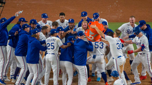 Oct 27, 2023; Arlington, Texas, USA; The Texas Rangers gather celebrate at home plate after right fielder Adolis Garcia (53) hits a walk-off home run to defeat the Arizona Diamondbacks during the eleventh inning in game one of the 2023 World Series at Globe Life Field. Mandatory Credit: Jerome Miron-USA TODAY Sports