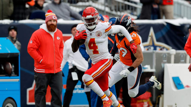 Oct 29, 2023; Denver, Colorado, USA; Kansas City Chiefs wide receiver Rashee Rice (4) runs the ball ahead of linebacker Alex Singleton (49) in the second quarter at Empower Field at Mile High. Mandatory Credit: Isaiah J. Downing-USA TODAY Sports  
