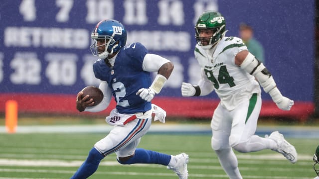 Oct 29, 2023; East Rutherford, New Jersey, USA; New York Giants quarterback Tyrod Taylor (2) carries the ball in front of New York Jets defensive end Solomon Thomas (94) during the first half at MetLife Stadium.