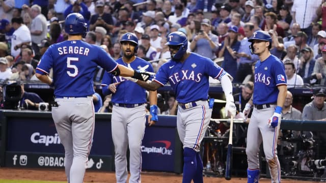Texas Rangers shortstop Corey Seager is congratulated after hitting a two-run home run against the Arizona Diamondbacks during the third inning in Game 3 of the 2023 World Series Monday at Chase Field, in Phoenix.
