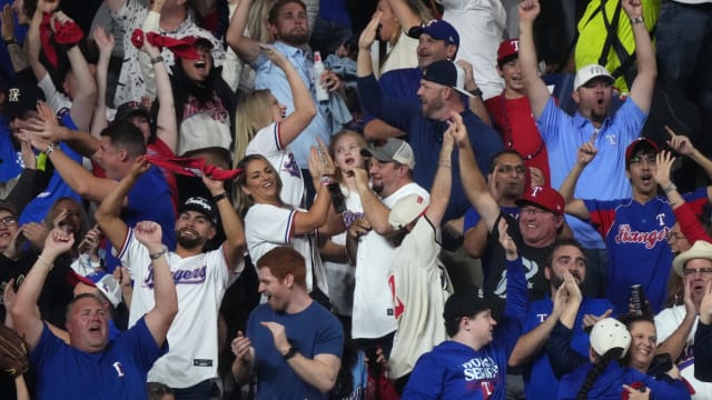 Texas Rangers fans celebrate in the stands after a home run by designated hitter Mitch Garver (not pictured) during the fifth inning against the Arizona Diamondbacks in game two of the 2023 World Series at Globe Life Field on Oct. 28, 2023, in Arlington, Texas.