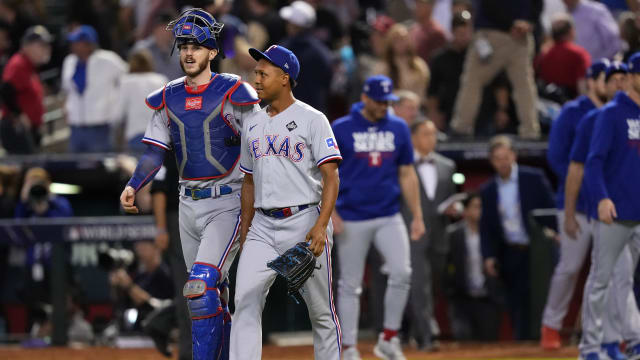 Texas Rangers closer Jose Leclerc, right, reacts with catcher Jonah Heim after finishing the club's 11-7 win over the Arizona Diamondbacks in Game 4 of the 2023 World Series Tuesday at Chase Field in Phoenix.