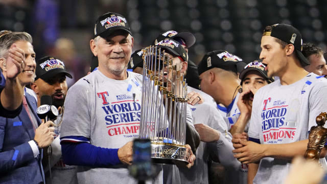 Texas Rangers manager Bruce Bochy celebrates with the Commissioner's Trophy after the Texas Rangers beat the Arizona Diamondbacks to win the World Series in Game 5 of the 2023 World Series Wednesday at Chase Field in Phoenix.