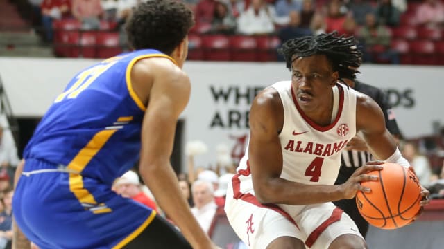 Nov 6, 2023; Tuscaloosa, Alabama, USA; Morehead State guard Trent Scott (11) defends as Alabama guard Davin Cosby Jr. (4) brings the ball into the front court in the game at Coleman Coliseum. Mandatory Credit: Gary Cosby Jr.-USA TODAY Sports