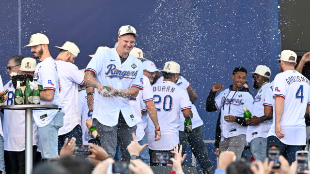 Nov 3, 2023; Arlington, TX, USA; Texas Rangers third baseman Josh Jung (6) sprays the crowd with champagne during the celebration outside of the ballpark after the World Series championship parade at Globe Life Field. Mandatory Credit: Jerome Miron-USA TODAY Sports