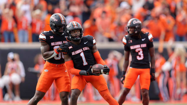 Oklahoma State's Xavier Benson (1) and Collin Oliver (30) celebrate a fumble recovery in the first half during a Bedlam college football game between the Oklahoma State University Cowboys (OSU) and the University of Oklahoma Sooners (OU) at Boone Pickens Stadium in Stillwater, Okla., Saturday, Nov. 4, 2023.