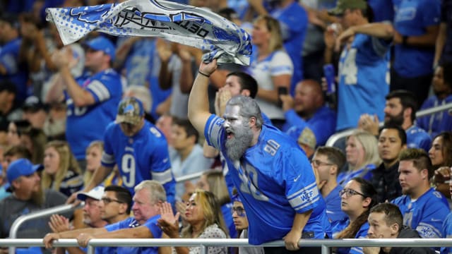 Detroit Lions fan cheers on team at Ford Field.