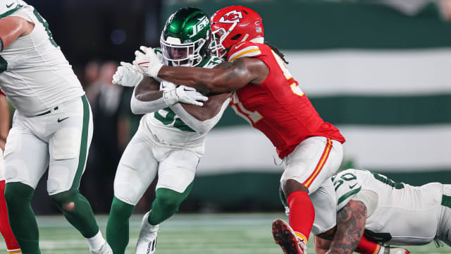 Jets' RB Michael Carter fights for yards against the Chiefs
