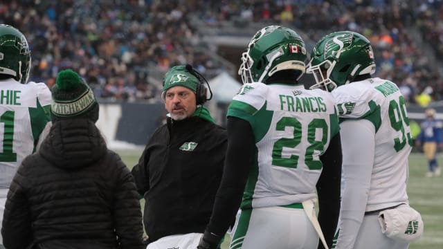 Dec 5, 2021; Winnipeg, Manitoba, CAN; Saskatchewan Roughriders head coach Craig Dickenson (center) talks with players on the sidelines during the game against the Winnipeg Blue Bombers during the Canadian football League Western Conference Final game at IG Field. Mandatory Credit: Bruce Fedyck-USA TODAY Sports