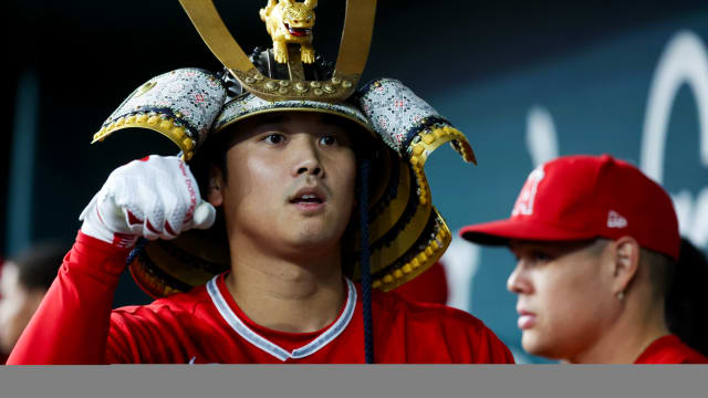 Aug 16, 2023; Arlington, Texas, USA; Los Angeles Angels designated hitter Shohei Ohtani (17) celebrates with teammates while wearing a samurai helmet after hitting a home run during the first inning against the Texas Rangers at Globe Life Field.