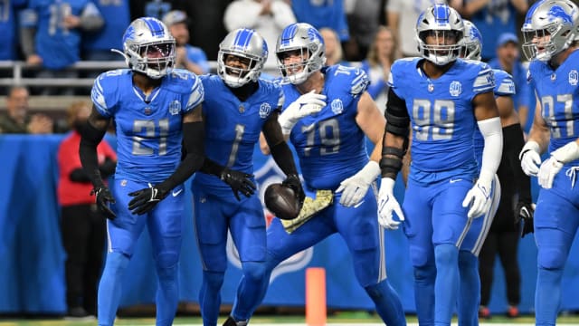 Detroit Lions defenders celebrate a fumble recovery against Chicago Bears.
