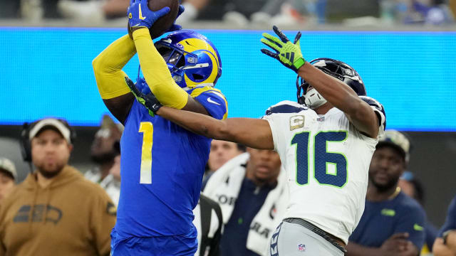 Los Angeles Rams cornerback Derion Kendrick (1) makes a catch against Seattle Seahawks wide receiver Tyler Lockett (16) in the fourth quarter at SoFi Stadium.