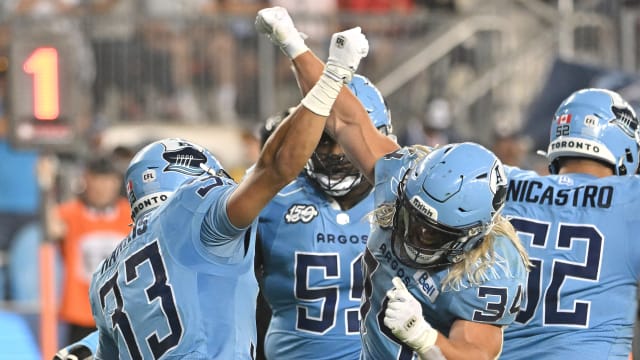 Jun 18, 2023; Toronto, Ontario, CAN; Toronto Argonauts running back Andrew Harris (32) celebrates with running back AJ Ouellette (33) after scoring a touchdown against the Hamilton Tiger-Cats in the fourth quarter at BMO Field. Mandatory Credit: Dan Hamilton-USA TODAY Sports