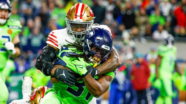 San Francisco 49ers linebacker Dre Greenlaw (57) tackles Seattle Seahawks running back DeeJay Dallas (31) following a reception by Dallas during the first quarter at Lumen Field.