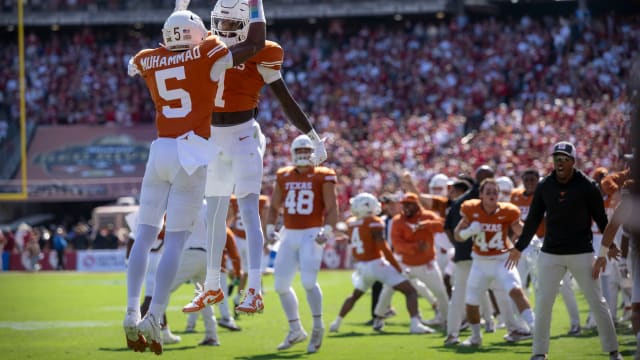 Oct 7, 2023; Dallas, Texas, USA; Texas Longhorns defensive back Malik Muhammad (5) and wide receiver Xavier Worthy (1) celebrate a touchdown against the Oklahoma Sooners during the first half at the Cotton Bowl. Mandatory Credit: Jerome Miron-USA TODAY Sports 