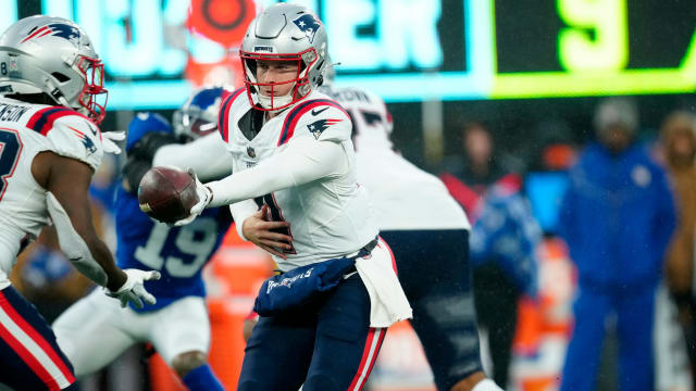 New England Patriots quarterback Bailey Zappe (4) prepares to handoff to New England Patriots running back Rhamondre Stevenson (38) 