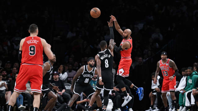 Chicago Bulls guard Jevon Carter (5) passes the ball to Chicago Bulls center Nikola Vucevic (9) as Brooklyn Nets forward Royce O'Neale (00) and Brooklyn Nets guard Lonnie Walker IV (8) defend during the second quarter at Barclays Center.