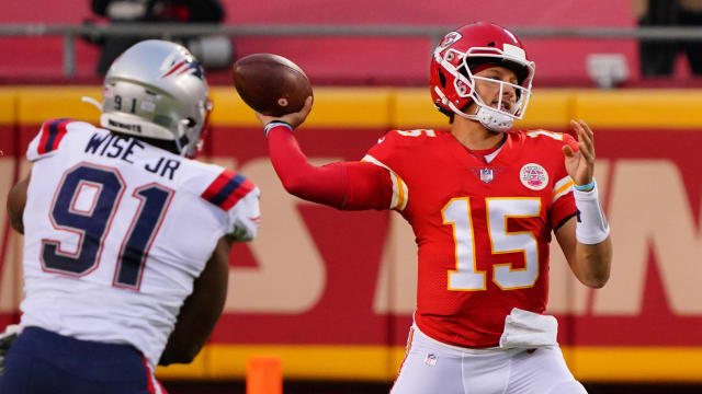 Oct 5, 2020; Kansas City, Missouri, USA; Kansas City Chiefs quarterback Patrick Mahomes (15) throws a pass against New England Patriots defensive end Deatrich Wise (91) during the first quarter of a NFL game at Arrowhead Stadium. Mandatory Credit: Jay Biggerstaff-USA TODAY Sports  