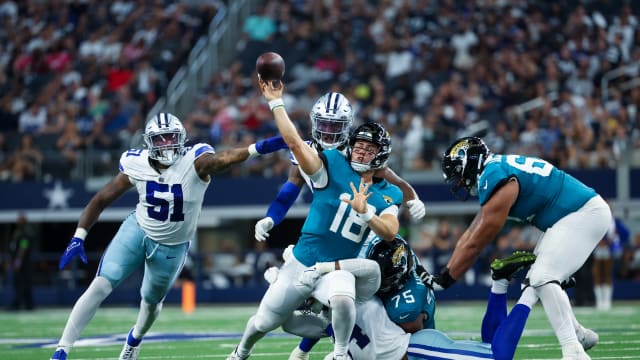 Aug 12, 2023; Arlington, Texas, USA; Jacksonville Jaguars quarterback Nathan Rourke (18) runs away from Dallas Cowboys defenders and throws a touchdown pass during the second half at AT&T Stadium. Mandatory Credit: Kevin Jairaj-USA TODAY Sports