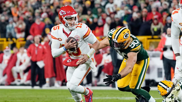 Dec 3, 2023; Green Bay, Wisconsin, USA; Kansas City Chiefs quarterback Patrick Mahomes (15) scrambles trying to avoid pressure from Green Bay Packers linebacker Lukas Van Ness (90) during the first quarter at Lambeau Field. Mandatory Credit: Jeff Hanisch-USA TODAY Sports  