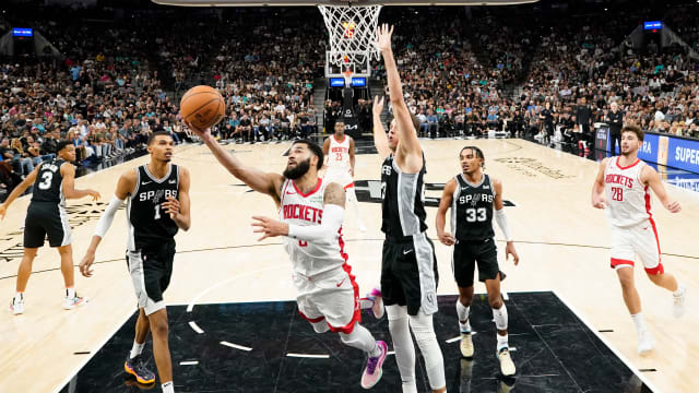 Houston Rockets guard Fred VanVleet (5) dries to the basket past San Antonio Spurs center Zach Collins (23) during the second half at Frost Bank Center.