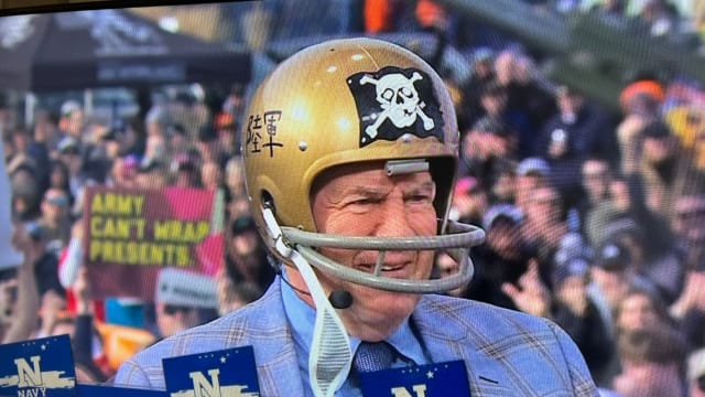Bill Belichick wears a 1962 Navy helmet, complete with its own version of the ‘Jolly Roger,’ to make his guest pick for the Army-Navy game at Gillette Stadium.