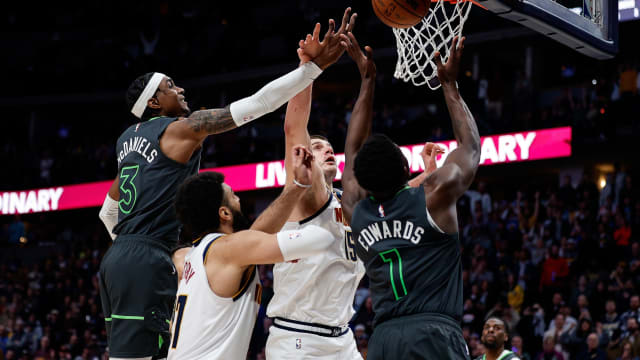 Jan 18, 2023; Denver, Colorado, USA; Denver Nuggets center Nikola Jokic (15) battles for a rebound with Minnesota Timberwolves forward Jaden McDaniels (3) and guard Anthony Edwards (1) as guard Jamal Murray (27) defends in the fourth quarter at Ball Arena.