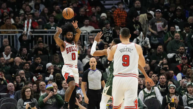 Chicago Bulls guard Coby White (0) passes the ball to center Nikola Vucevic (9) during the third quarter against the Milwaukee Bucks at Fiserv Forum.