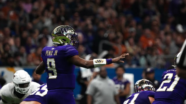 Washington Huskies quarterback Michael Penix Jr. (9) lines up the offense for a snap against Texas during the Alamo Bowl at the Alamodome, Thursday, Dec. 29, 2022 in San Antonio