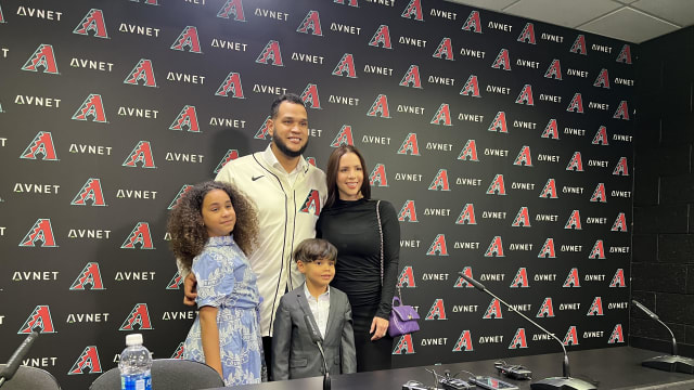 Arizona Diamondbacks left-handed pitcher Eduardo Rodriguez poses for a photo with his family in the Chase Field interview room.