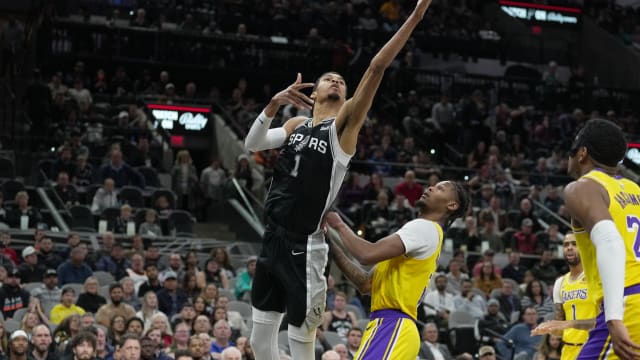 Dec 13, 2023; San Antonio, Texas, USA; San Antonio Spurs center Victor Wembanyama (1) shoots over Los Angeles Lakers forward Cam Reddish (5) in the first half at the Frost Bank Center.