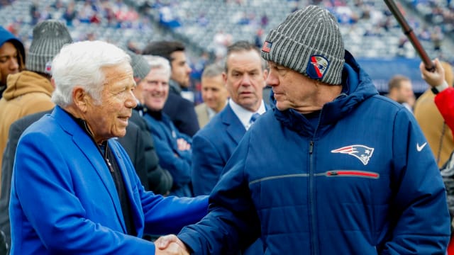 New England Patriots owner Robert Kraft (left) shares a pregame handshake with coach Bill Belichick.