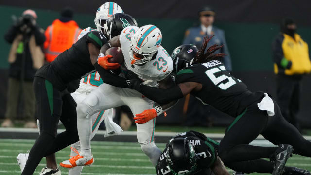 Miami RB Jeff Wilson is stopped by Sauce Gardner and CJ Mosley