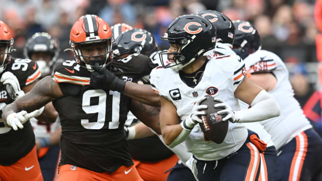 Dec 17, 2023; Cleveland, Ohio, USA; Chicago Bears quarterback Justin Fields (1) scrambles as Cleveland Browns defensive end Alex Wright (91) rushes during the first quarter at Cleveland Browns Stadium. Mandatory Credit: Ken Blaze-USA TODAY Sports