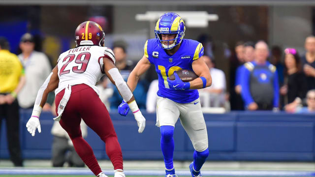 Los Angeles Rams wide receiver Cooper Kupp (10) runs the ball against Washington Commanders cornerback Kendall Fuller (29) during the first half at SoFi Stadium.