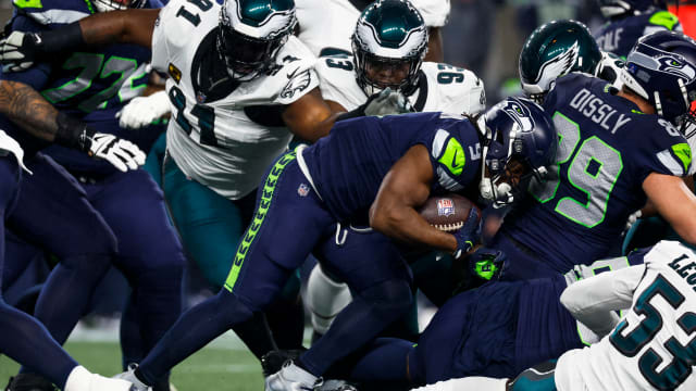 Seattle Seahawks running back Kenneth Walker III (9) rushes against Philadelphia Eagles defensive tackle Fletcher Cox (91) and defensive tackle Milton Williams (93) during the first quarter at Lumen Field.