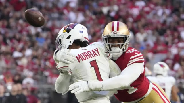 Arizona Cardinals quarterback Kyler Murray (1) delivers a pass while hit by San Francisco 49ers defensive end Clelin Ferrell (94) during the third quarter at State Farm Stadium.
