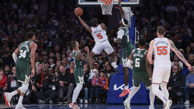 New York Knicks guard Immanuel Quickley (5) drives to the basket as Milwaukee Bucks forward Bobby Portis (9) and guard Damian Lillard (0) 