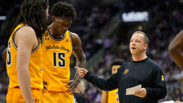 Dec 21, 2023; Kansas City, Missouri, USA; Wichita State Shockers head coach Paul Mills talks to his team during a timeout in the first half against the Kansas State Wildcats at T-Mobile Center.