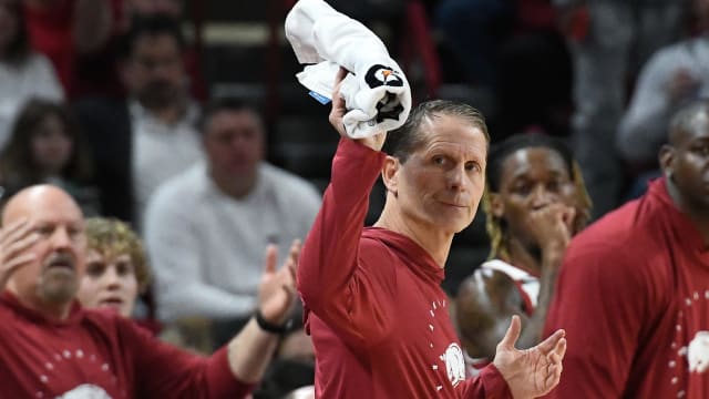 Razorbacks coach Eric Musselman waves towel after a call against UNC Wilmington