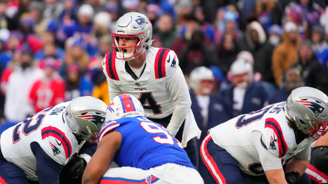 New England Patriots quarterback Bailey Zappe (4) calls out signals prior to the snap during the second half against the Buffalo Bills at Highmark Stadium.