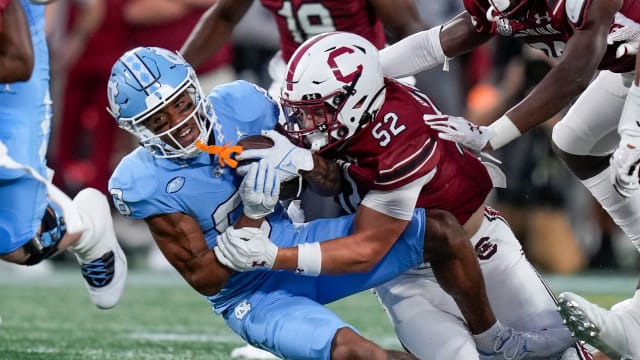 North Carolina Tar Heels wide receiver Kobe Paysour (8) is tackled by South Carolina Gamecocks linebacker Stone Blanton (52) during the first quarter at Bank of America Stadium.