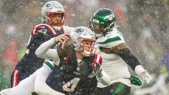 New England Patriots quarterback Bailey Zappe (4) is sacked by New York Jets linebacker Bryce Huff (47) in the first half at Gillette Stadium.