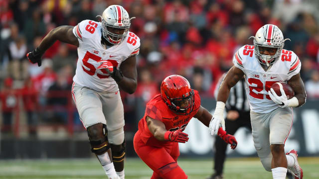 Nov 12, 2016; College Park, MD, USA; Ohio State Buckeyes running back Mike Weber (25) runs past Maryland Terrapins linebacker Jermaine Carter Jr. (23) during the second quarter at Capital One Field at Maryland Stadium. Mandatory Credit: Tommy Gilligan-USA TODAY Sports  