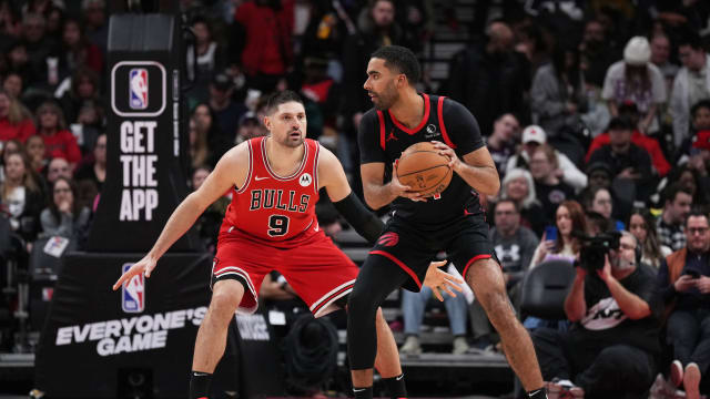 Toronto Raptors forward Jontay Porter (34) controls the ball as Chicago Bulls center Nikola Vucevic (9) tries to defend the third quarter at Scotiabank Arena.