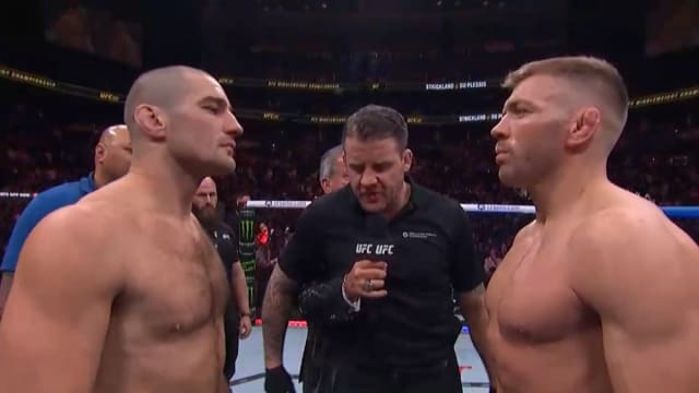Sean Strickland and Dricus Du Plessis stare down before the first round of their UFC 297 title fight.