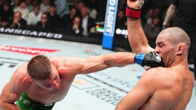 Dricus Du Plessis scores a punch on Sean Strickland during their UFC 297 title fight.